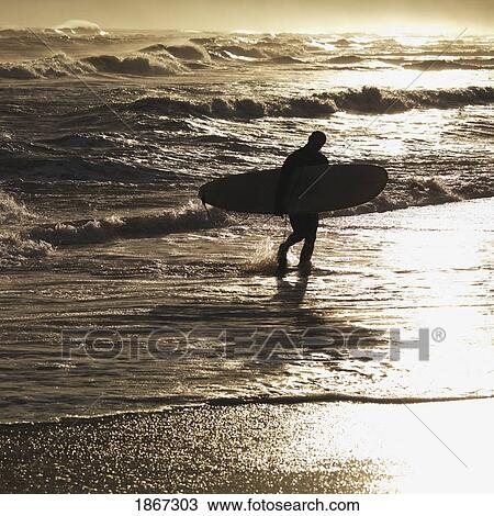 Silhouette Of Man Carrying Surfboard, Sag Harbor; New York, Usa View Large Photo Image Stock Image - Silhouette Of Man Carrying Surfboard, Sag Harbor; New York, Usa. Fotosearch