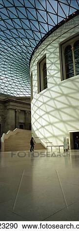 Stock Image - Silhouette Of Man Passing Reading Room In Great Court Of British Museum, London, England. Fotosearch