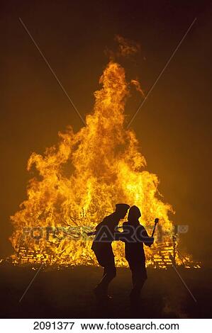 Silhouette Of Man Teaching His Son How To Throw Burning Torches On To Large Bonfire At Barcombe Bonfire Night, Barcombe, East Sussex, Uk View Large Photo Image Stock Photo - Silhouette Of Man Teaching His Son How To Throw Burning Torches On To Large Bonfire At Barcombe Bonfire Night, Barcombe, East Sussex, Uk. Fotosearch