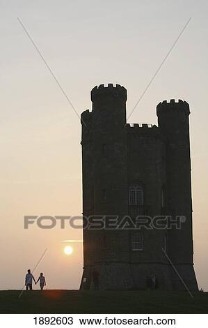 Stock Image - Silhouette Of Romantic Couple And Broadway Tower, Dusk. Fotosearch