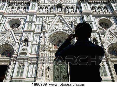 Stock Photo - Silhouette Of Woman Taking Photograph Of The Facade Of The Duomo. Fotosearch