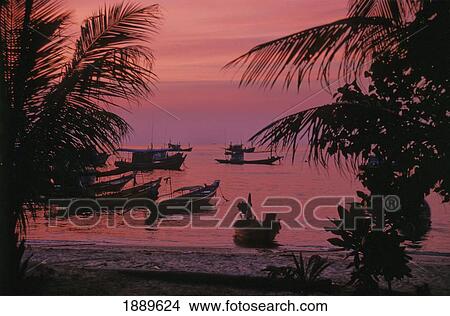 Picture - Silhouetted Boats Off Beach At Sunset. Fotosearch