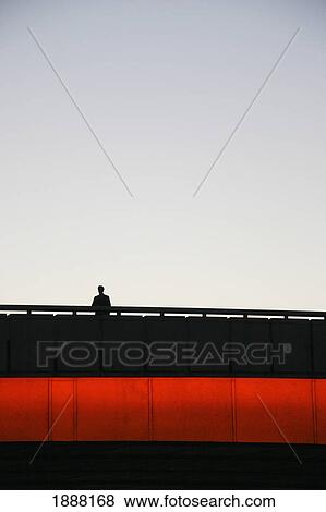 Stock Photo - Silhouetted Man Standing On London Bridge. Fotosearch