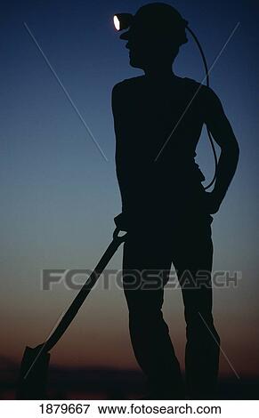 Silhouetted Miner With Lit Hat And Shovel View Large Photo Image Stock Photo - Silhouetted Miner With Lit Hat And Shovel. Fotosearch