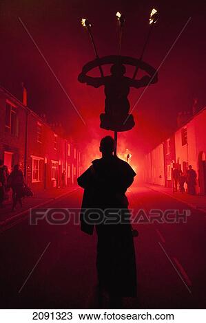 Silhouettes Of Monk With Banner Lit By Red Flare Walking Through Smokey Backstreets Of Lewes On Bonfire Night, East Sussex, Uk View Large Photo Image Stock Image - Silhouettes Of Monk With Banner Lit By Red Flare Walking Through Smokey Backstreets Of Lewes On Bonfire Night, East Sussex, Uk. Fotosearch