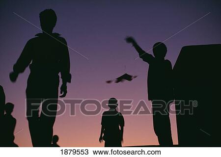 Silhouettes Of People Flying Kites View Large Photo Image Stock Image - Silhouettes Of People Flying Kites. Fotosearch