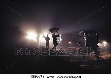 Silhouettes Of Traffic And People Carrying Sacks On Their Heads At Night View Large Photo Image Stock Image - Silhouettes Of Traffic And People Carrying Sacks On Their Heads At Night. Fotosearch