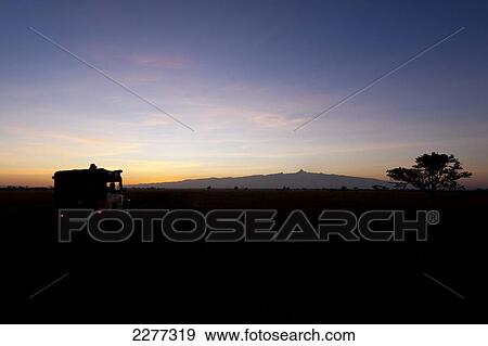 Silhoutte of 4x4 at dawn in front of Mt Kenya, Ol Pejeta Conservancy; Kenya View Large Photo Image Stock Photo - Silhoutte of 4x4 at dawn in front of Mt Kenya, Ol Pejeta Conservancy; Kenya. Fotosearch