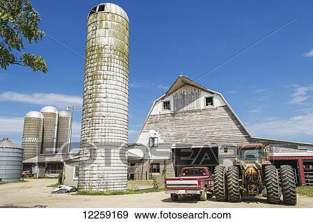 Silos and wooden barn needing paint; Ridgley, Maryland, United States of America View Large Photo Image Stock Photo - Silos and wooden barn needing paint; Ridgley, Maryland, United States of America. Fotosearch