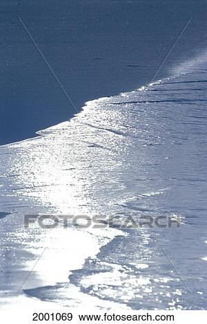 Stock Photo - Silver Ocean Reflections Along Shoreline, Dark Gray Charcoal Sand. Fotosearch