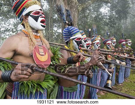 Stock Image - Sing-Sing at Paiyagona Village, men in a line, Western Highlands, Papua New Guinea., Western Highlands, Papua New Guinea.. Fotosearch