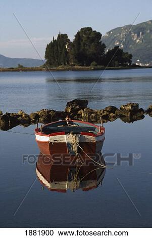 Stock Image - Single Boat On Estuary. Fotosearch