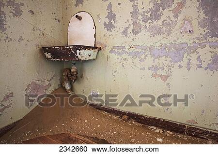 Stock Image - Sink And Sand In Abandoned House; Kolmanskop Ghost Town, Namibia. Fotosearch