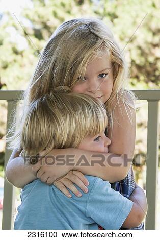 Sister Hugging Her Younger Brother; Ontario Canada View Large Photo Image Stock Image - Sister Hugging Her Younger Brother; Ontario Canada. Fotosearch