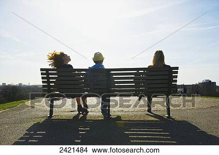 Picture - Sitting on a bench in the sunshine with a view of the city, Primrose Hill; London, England. Fotosearch