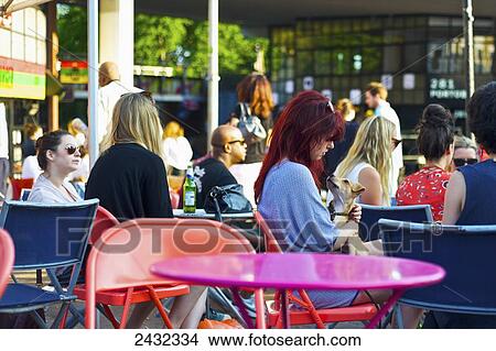 Sitting on a patio area at Portobello Market, Notting Hill; London, England View Large Photo Image Picture - Sitting on a patio area at Portobello Market, Notting Hill; London, England. Fotosearch