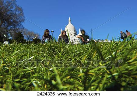 Sitting on the grass with a view of a building's white dome roof in the background; Paris, France View Large Photo Image Stock Photograph - Sitting on the grass with a view of a building's white dome roof in the background; Paris, France. Fotosearch