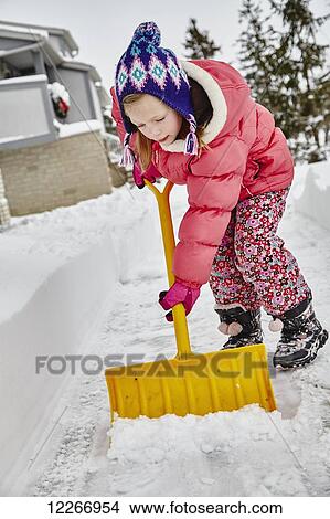 Six-year-old, Caucasian girl shoveling snow off the driveway; Ontario, Canada View Large Photo Image Picture - Six-year-old, Caucasian girl shoveling snow off the driveway; Ontario, Canada. Fotosearch