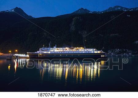 Skagway, Alaska, United States Of America; The Alaska Ferry Surrounded By The Chilkat Mountains In The Lynn Canal Of The Taiya Inlet View Large Photo Image Stock Photo - Skagway, Alaska, United States Of America; The Alaska Ferry Surrounded By The Chilkat Mountains In The Lynn Canal Of The Taiya Inlet. Fotosearch