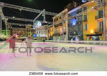 Skating on an outdoor ice rink; Locarno, Ticino, Switzerland View Large Photo Image Stock Photo - Skating on an outdoor ice rink; Locarno, Ticino, Switzerland. Fotosearch