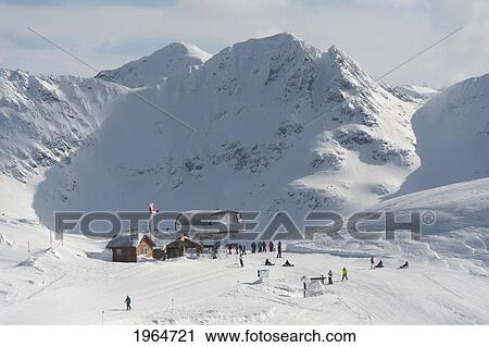 Stock Image - Skiers At A Meeting Point On A Hill At A Ski Resort; Whistler British Columbia Canada. Fotosearch