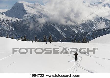 Skiers Forge New Tracks In Fresh Snow; Whistler British Columbia Canada View Large Photo Image Stock Image - Skiers Forge New Tracks In Fresh Snow; Whistler British Columbia Canada. Fotosearch