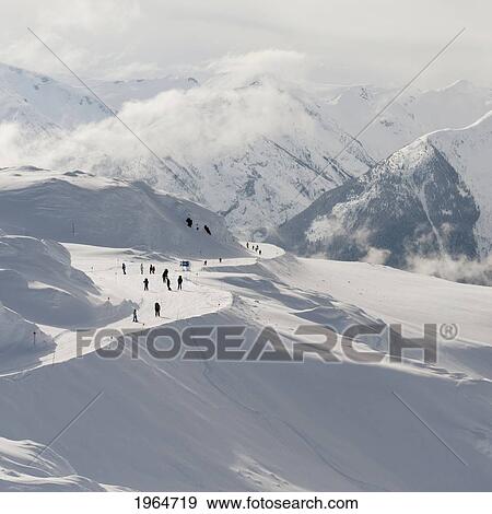 Stock Photo - Skiers On A Snowy Trail On A Mountain; Whistler British Columbia Canada. Fotosearch