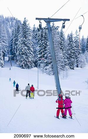 Skiers On Lift Up The Mountain Ski And Snowboard Resort In Waidring, Austrian Alps, Austria View Large Photo Image Stock Photo - Skiers On Lift Up The Mountain Ski And Snowboard Resort In Waidring, Austrian Alps, Austria. Fotosearch