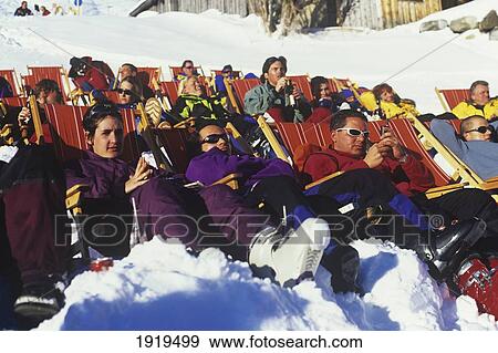 Skiers Sitting On Deck Chairs View Large Photo Image Stock Photo - Skiers Sitting On Deck Chairs. Fotosearch