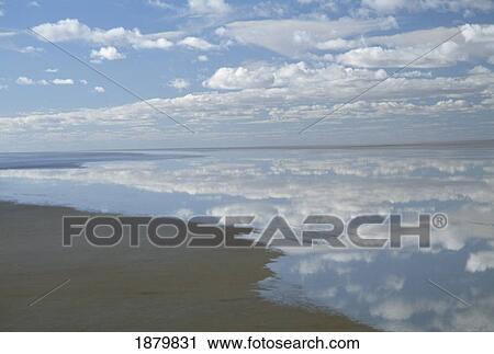 Stock Image - Sky With Clouds Reflecting On Still Waters. Fotosearch