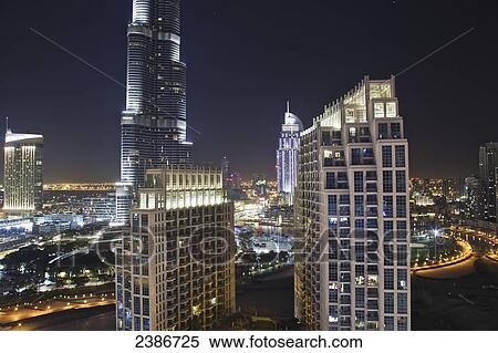 Skyline of skyscrapers in Dubai at nighttime; Dubai, United Arab Emirates View Large Photo Image Stock Photography - Skyline of skyscrapers in Dubai at nighttime; Dubai, United Arab Emirates. Fotosearch