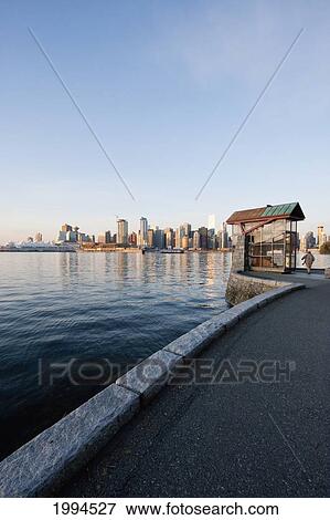 Skyline Of Vancouver And Nine O'clock Gun In Stanley Park, British Columbia, Canada View Large Photo Image Stock Photo - Skyline Of Vancouver And Nine O'clock Gun In Stanley Park, British Columbia, Canada. Fotosearch
