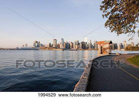 Skyline Of Vancouver And Nine O'clock Gun In Stanley Park, British Columbia, Canada View Large Photo Image Stock Photo - Skyline Of Vancouver And Nine O'clock Gun In Stanley Park, British Columbia, Canada. Fotosearch