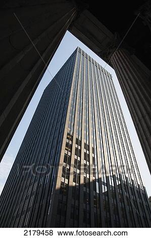 Stock Photo - Skyscraper Viewed Through The Columns Of A Building; Montreal Quebec Canada. Fotosearch