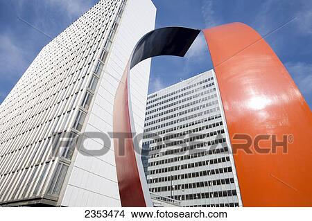 Picture - Skyscrapers And An Orange Curved Sculpture; Stockholm, Sweden. Fotosearch