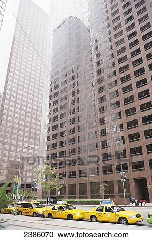 Skyscrapers and taxis lined up on the street; California, United States of America View Large Photo Image Stock Image - Skyscrapers and taxis lined up on the street; California, United States of America. Fotosearch