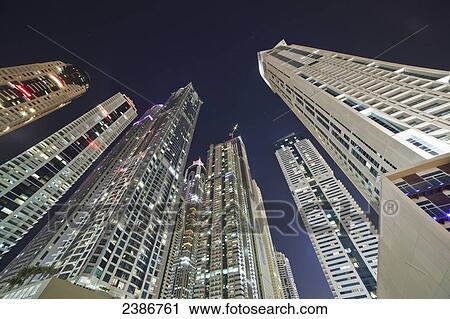 Skyscrapers illuminated at nighttime; Dubai, United Arab Emirates View Large Photo Image Stock Image - Skyscrapers illuminated at nighttime; Dubai, United Arab Emirates. Fotosearch