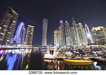 Skyscrapers illuminated at nighttime and boats in the marina; Dubai, United Arab Emirates View Large Photo Image Stock Photography - Skyscrapers illuminated at nighttime and boats in the marina; Dubai, United Arab Emirates. Fotosearch
