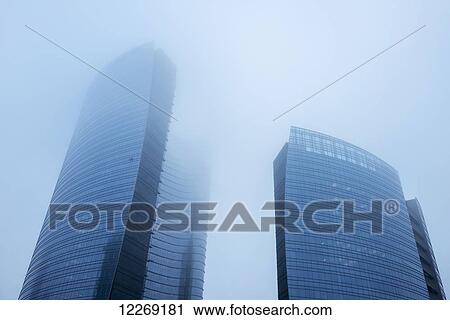 Stock Image - Skyscrapers in the fog in the business district, Porta Nuova; Milan, Lombardy, Italy. Fotosearch