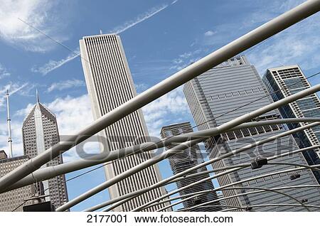 Stock Image - Skyscrapers Viewed Through A Grey Metal Railing; Chicago Illinois United States Of America. Fotosearch