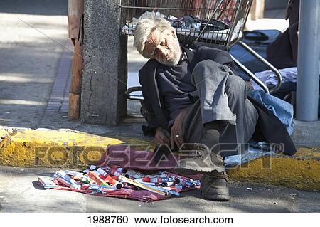 Stock Image - Sleeping Vendor On Uruguay Street, Valparaiso, Valparaiso Region, Chile. Fotosearch