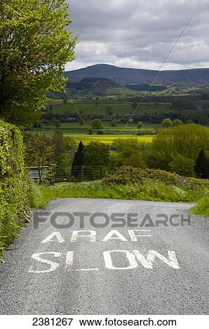 Slow sign painted on the road; Brecon Beacons, Wales View Large Photo Image Stock Photo - Slow sign painted on the road; Brecon Beacons, Wales. Fotosearch