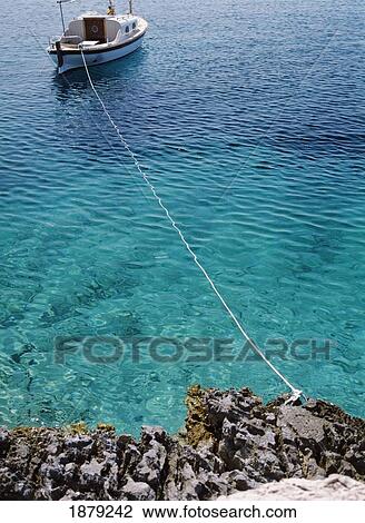 Stock Image - Small Boat Moored In Bay On The Island Of Sveti Klement. Fotosearch