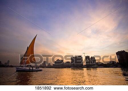 Small Boats In Water By A City At Dusk; Cairo, Egypt, Africa View Large Photo Image Stock Image - Small Boats In Water By A City At Dusk; Cairo, Egypt, Africa. Fotosearch