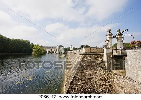 Stock Image - Small Bridge Over A Canal By The Chateau De Chenonceau On The River Cher, Chenonceau, Indre-Et-Loire, France. Fotosearch