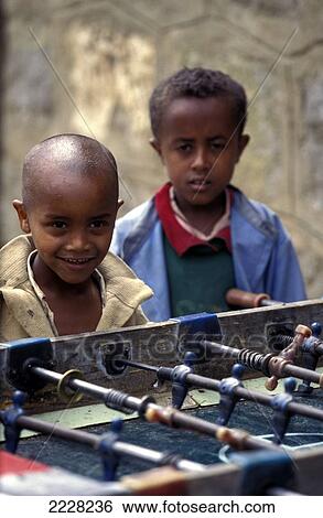 Stock Photograph - Small Children Playing Table Football In A Slum In Addis Ababa, Ethiopia. Fotosearch