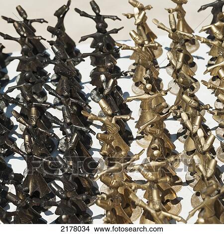 Picture - Small Dancing Figurines Made Of Gold And Black Metal; Nevsehir Turkey. Fotosearch
