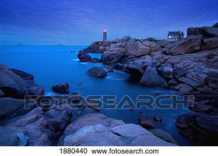 Stock Image - Small Lighthouse And House At Dusk. Fotosearch