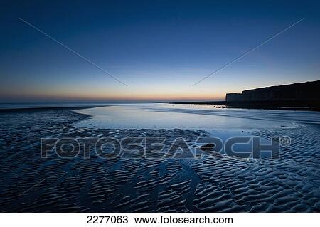 Small pool in sand at low tide at Cuckmere Haven at dusk; East Sussex, England View Large Photo Image Stock Image - Small pool in sand at low tide at Cuckmere Haven at dusk; East Sussex, England. Fotosearch