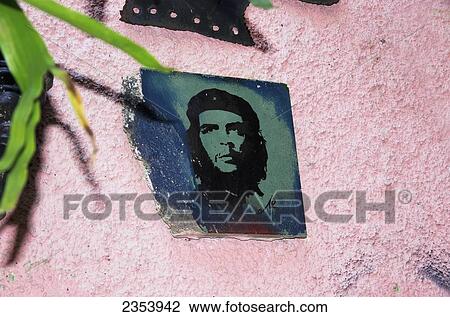 Stock Image - Small Portrait Of Che Guevara On A Pink Stucco Wall In Shop On Callejon De Hamel; Havana, Artemisa, Cuba. Fotosearch